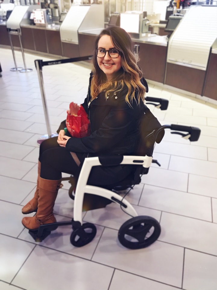 Woman sitting in a wheelchair with a bag of chips in her hands