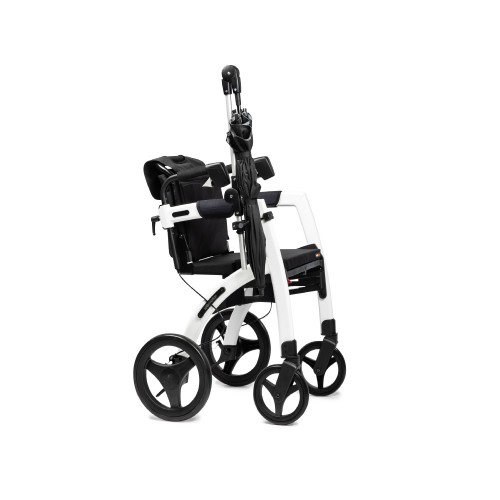 Rollz Moton umbrella folded and attached to the frame of a white rollator
